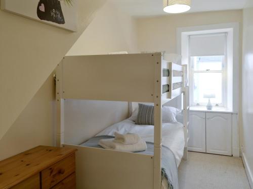 a bedroom with a bunk bed in a room at Buckle House in Gatehouse of Fleet