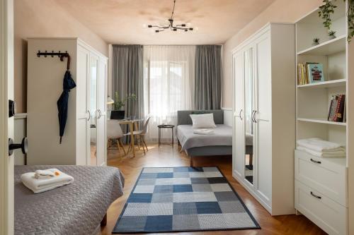 a bedroom with a bed and a living room at 1800 by Vince Stay - Private Rooms in Town Hall Square in Tartu
