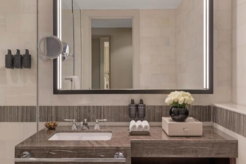a bathroom with a sink and a mirror at Jumeirah Jabal Omar Makkah in Makkah