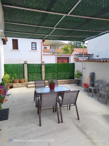 a patio with a table and chairs under a pergola at Villa Stella in Maronia
