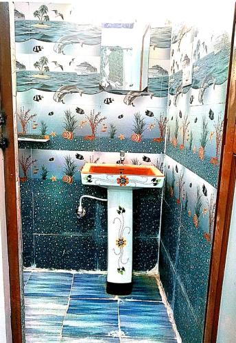 a bathroom with a sink and a wall at maa kalishila home stay in Ukhimath