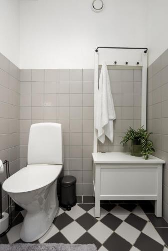 a white bathroom with a toilet and a sink at 1800 by Vince Stay - Private Rooms in Town Hall Square in Tartu