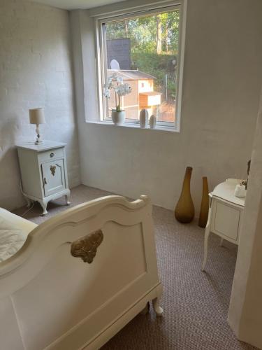 a bedroom with a bed and a window at Winding B&B Silkeborg in Silkeborg