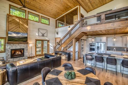 a large living room with a staircase and a fireplace at Mountain Majesty - Views Style & Relaxation in Morganton
