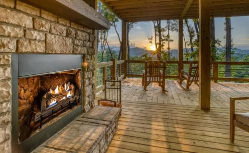 a fireplace on the deck of a house at Mountain Majesty - Views Style & Relaxation in Morganton