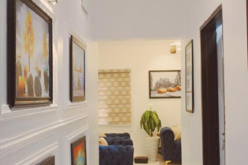 a living room with couches and paintings on the walls at Flixx & Flixx Apartments - Eleyele Ibadan in Ibadan