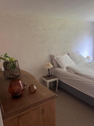 a bedroom with a bed and a table with a lamp at Winding B&B Silkeborg in Silkeborg