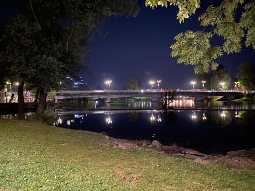 a bridge over a river at night at Apartments & Rooms Fountain in Bihać