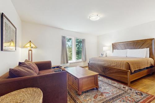 a bedroom with a bed and a couch at Rose's Reach - Rosario in Eastsound