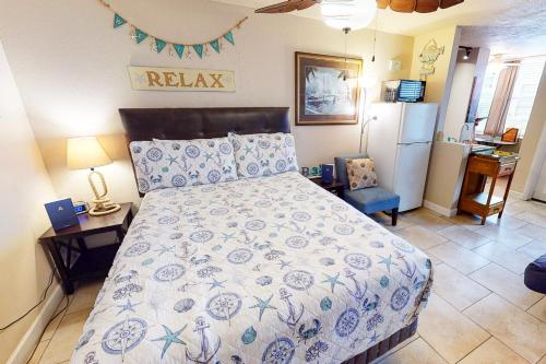 a bedroom with a bed and a refrigerator at Ocean Jewel Condo Unit 303 in Daytona Beach