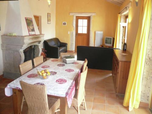 a dining room with a table and a fireplace at Sunny Escape to Serenity in Fraissé-des-Corbières