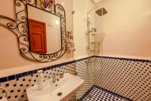 a bathroom with a sink and a mirror at Riad Diamant De Fes in Fès