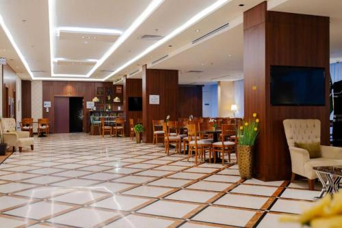 a restaurant with tables and chairs in a room at Dancenter Red Sea Fountain Alhamra Vivid Plaza Hotel in Jeddah