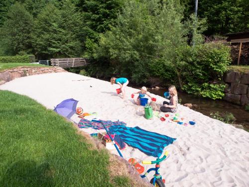 a group of children playing in the sand at Schwarzwaldstrand Ferienwohnungen in Bad Herrenalb