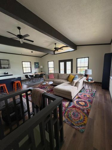 a living room with a couch and a table at Modern Mountainside Cabin in Bella Vista