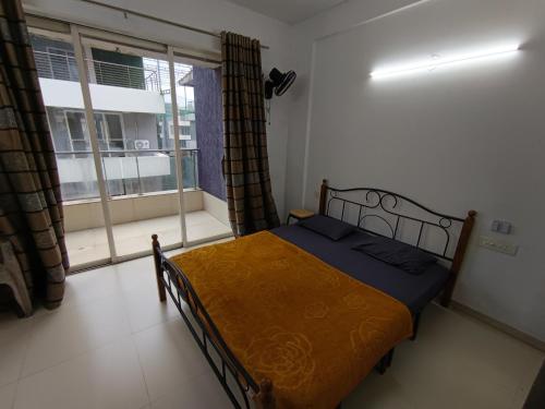 a small bedroom with a bed and a window at Sky line villa, Lonavla in Lonavala