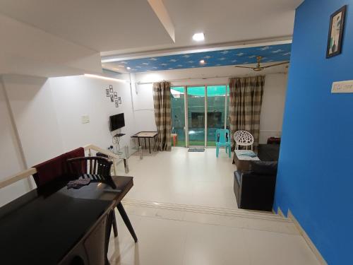 a living room with a couch and a table at Sky line villa, Lonavla in Lonavala