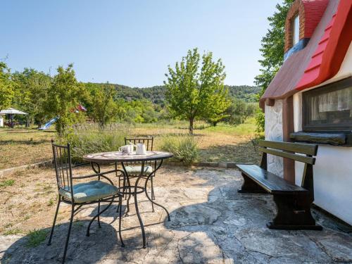 a patio with a table and chairs and a bench at Holiday Home Little Castle by Interhome in Skradin