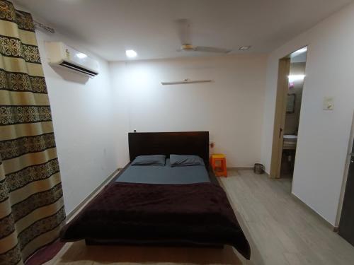 a bedroom with a bed in the corner of a room at Sky line villa, Lonavla in Lonavala