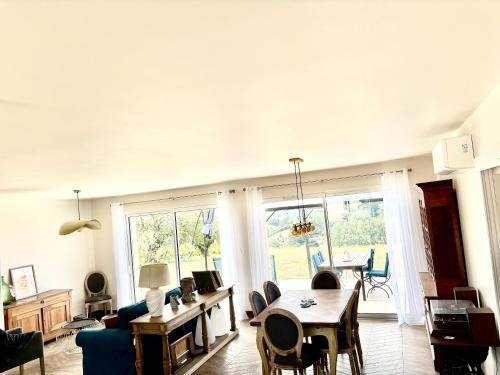 a living room with a table and a dining room at Maison La Vigne in Marcillac-Saint-Quentin