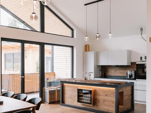 a kitchen with a fireplace in the middle of a room at Holiday Home Haus am Kogl by Interhome in Wies
