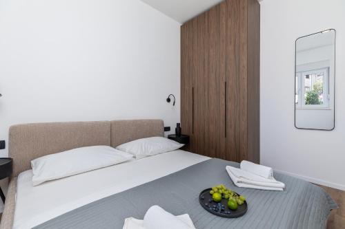 a bedroom with a bed with a tray of fruit on it at Penthouse Andro, Omis in Omiš