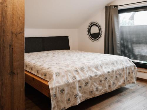 a bedroom with a bed and a window at Holiday Home Haus am Kogl by Interhome in Wies