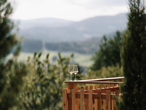 a wine glass sitting on top of a wooden fence at Holiday Home Haus am Kogl by Interhome in Wies