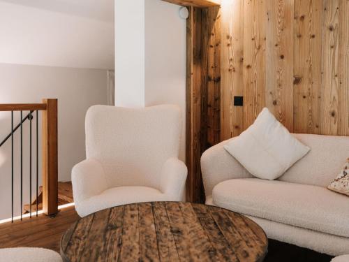 a living room with two chairs and a table at Holiday Home Haus am Kogl by Interhome in Wies