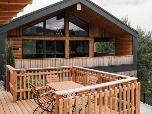 a house with a deck with a table and chairs at Holiday Home Haus am Kogl by Interhome in Wies