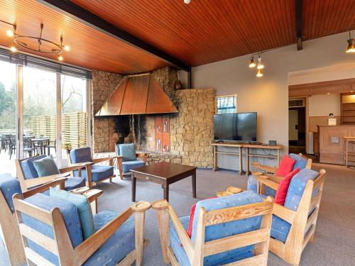 a living room with chairs and a table and a tv at Pet-Friendly Escape in Fauvillers in Fauvillers