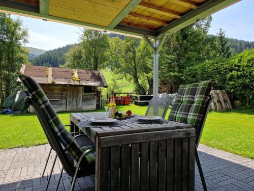a wooden table and chairs on a patio at Apartment Jenewein by Interhome in Obernberg am Brenner