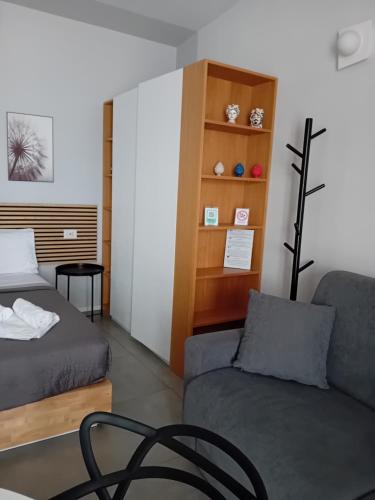 a room with a bed and a couch and a chair at Porta San Paolo House in Castelbuono