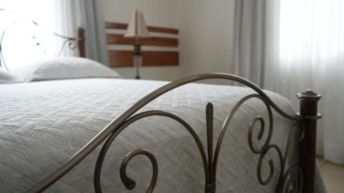 a close up of a bed with a white mattress at Hotel Casa del Arbol in San Pedro Sula