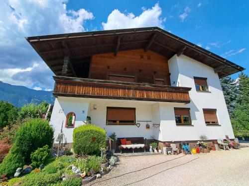 a large white house with a large roof at Apartment Angelika by Interhome in Brixlegg