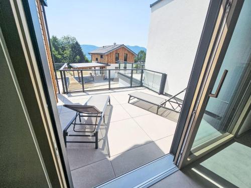 a view of a balcony with a table and chairs at Chalet Ossiacher See Chalet 2 by Interhome in Bodensdorf