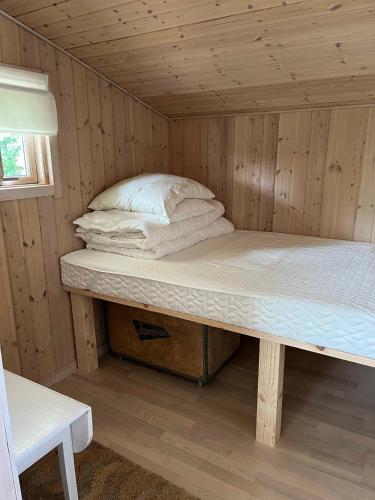 a room with a bunk bed in a wooden room at Holiday Home Close To The Beach In Nødebohuse in Hundested