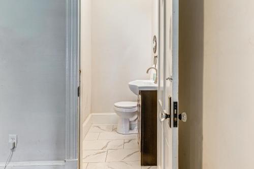 a bathroom with a toilet and a sink at Walk to Main St Shops and Dining Stroudsburg Unit! in Stroudsburg
