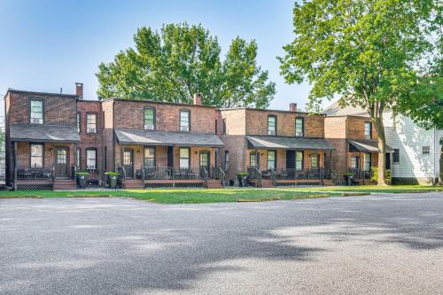 a large brick building with benches in front of a street at 1 Block to Stroudsburg Main St Chic Townhome in Stroudsburg
