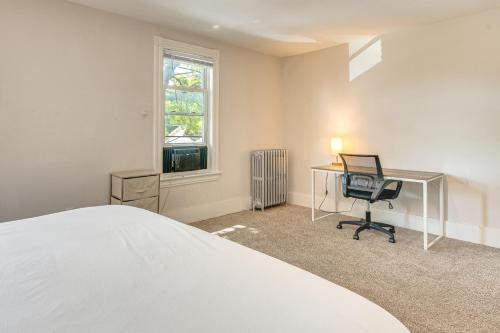 a bedroom with a bed and a desk and a chair at Shop and Dine Central Stroudsburg Townhome! in Stroudsburg