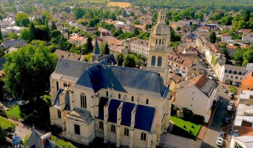 an aerial view of a town with a church at Apartment T2 L'Isle Adam, Garden Terrace in LʼIsle-Adam