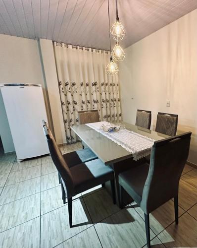 a dining table and chairs in a room at Morada Felicitá in Pato Branco