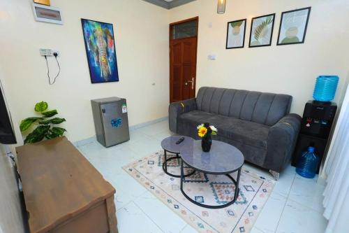a living room with a couch and a table at The Loft in Mombasa