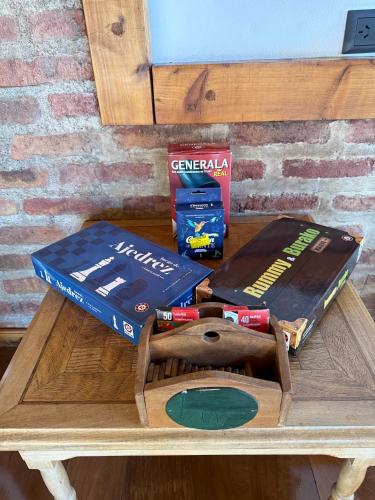 a wooden table with two boxes on top of it at Hosteria Las Walkirias in San Martín de los Andes