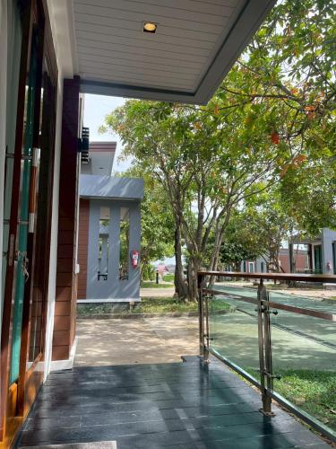 an open door of a building with a tennis court at Nutchana Hill Boutique Hotel in Ban Thung Ri