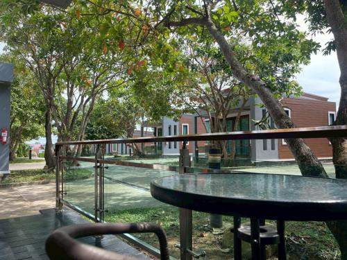 a glass table in front of a tree at Nutchana Hill Boutique Hotel in Ban Thung Ri