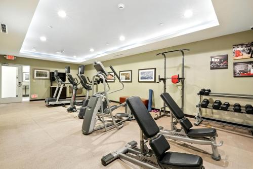 a gym with several treadmills and cardio machines at Relux at Westchase in Houston