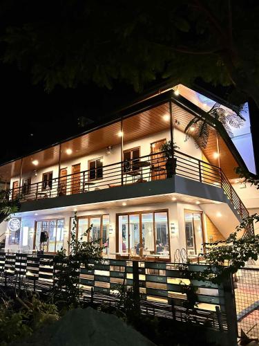 a large white building with a balcony at night at The River House - Govantes Guesthouse in Vigan