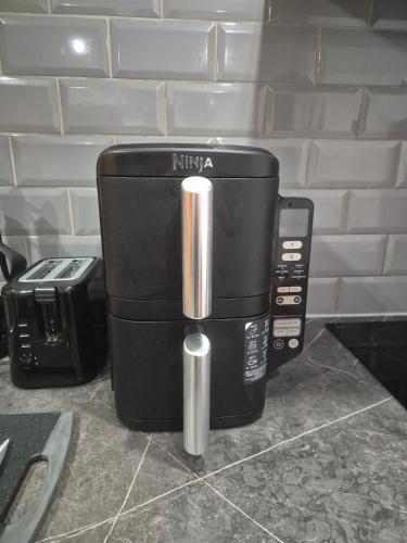 a coffee maker sitting on a counter next to a toaster at The Orange Outpost 8a - City Centre in Bradford