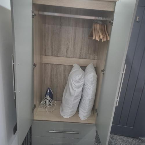a couple of pillows are sitting in a closet at The Orange Outpost 8a - City Centre in Bradford